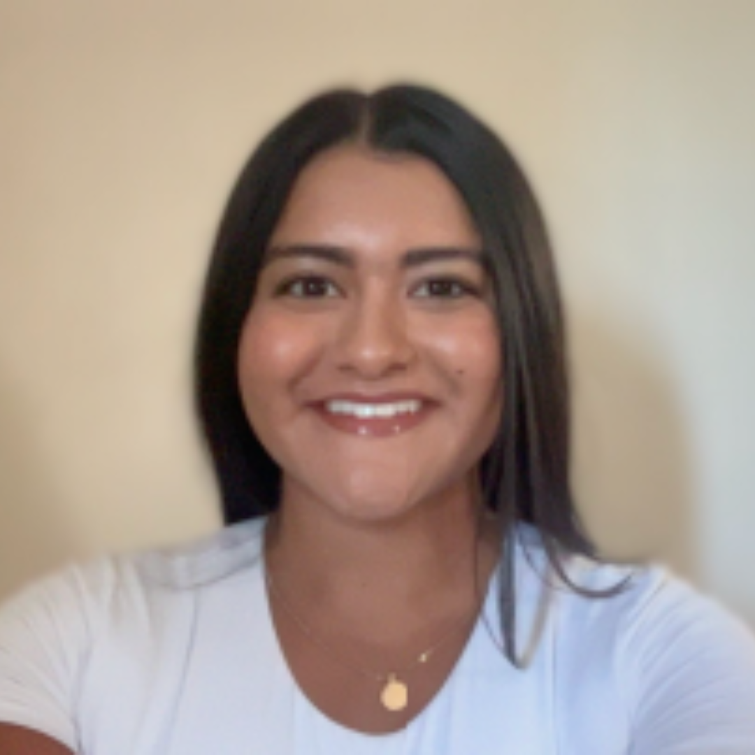 EMPH Student Jocelyn Mendoza wearing white t-shirt and gold chain necklace and brown long straight hair parted down the center