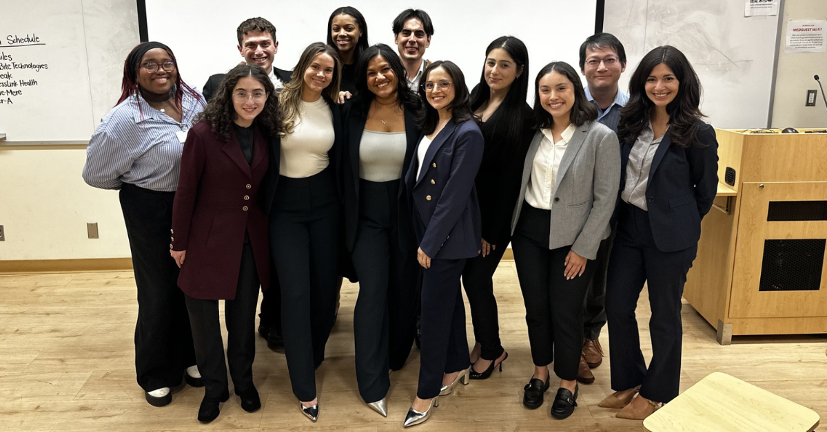 A group of twelve UCLA Executive MPH (EMPH) students smiling together in a classroom following their 2026 Business Plan Presentations. The students are professionally dressed in business attire. Student participants pictured include: Kennedy Anderson, Nicollette Doomany, Alexa Osime, Emily Brown, Maite Medina, RN, Trishna Singh, Miguel Ramirez, Rui Zhao, Sarah Hakakha, Zachary Morganstein, Marina Martinez, Maya Camacho