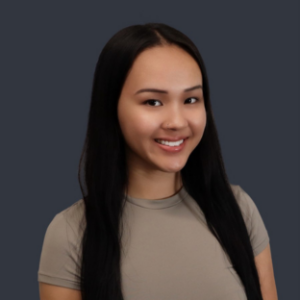 headshot of UCLA Executive MPH student Jessica Pham. She has long, straight black hair parted down the center and hanging in front of her shoulders. She wears a light grey short sleeve top.