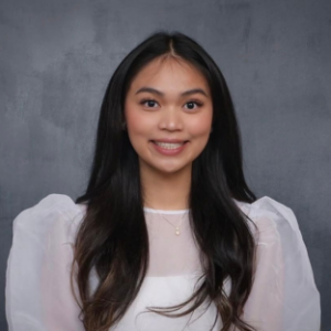 headshot of UCLA EMPH student (class of 2028) Sofia Fernando. She has long straight black hair and she wears a white top with puffy sheer sleeves. She is smiling