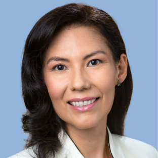 Headshot of UCLA EMPH student Dr. Martha Vega. She has shoulder length straight black hair and she is wearing a white physician coat